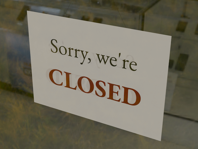 A picture of a sign saying \'Sorry, we're closed\' on both sides